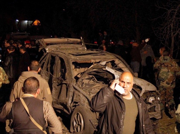 Lebanese army soldiers inspect a burned car at the site of an explosion next to Imam Ali mosque in Al Nabi Uthman town near the Syrian border, Lebanon, 16 March 2014. A suicide bomber blew himself up in Al Nabi Uthman in the country's north-east, killing two people and wounding at least 11, initial reports say. The Al-Qaeda linked Al Nusra Front in Lebanon claimed responsibility for the Al Nabi Uthman attack.