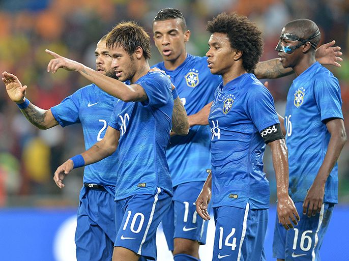 Brazil's forward Neymar (2nd-L) celebrates with teammates after scoring his team's fifth goal during a friendly football match between South Africa and Brazil at Soccer City stadium in Soweto, outside Johannesburg, on March 5, 2014 ahead of the 2014 FIFA World Cup football tournament. Neymar scored a hat-trick as Brazil ended a run of narrow victories over South Africa by cruising to a 5-0 triumph. AFP PHOTO / ALEXANDER JOE