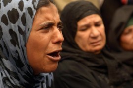 A relative of a supporter of Egyptian ousted Islamist president Mohamed Morsi cries outside the courthouse on March 25, 2014 in the central Egyptian city of Minya, during a session of the trial of some 700 Islamists charged with deadly rioting in an Egypt city. The court that the day before sentenced to death 529 alleged supporters of Morsi will sentence nearly 700 more on April 28, a lawyer said, after the hearing was adjourned. AFP PHOTO / STR