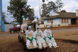 (FILES) This picture taken on April 9, 2005 shows five health workers, dressed in head-to-toe "Ebola suits", leaving in a pick-up truck in Uige, about 300km north of the Angolan capital, Luanda, to collect a man dying from haemorrhagic fever. The Ebola virus has been identified as the source of an outbreak of hemorrhagic fever in southern Guinea, the west African nation said on March 22, 2014 as the death toll rose to 34. AFP