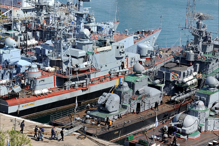 Russian military ships, including former the Ukrainian corvette Khmelnitsky (3rd R), which was seized by pro-Russian forces last week, are moored in the bay of the Crimean city of Sevastopol on March 24, 2014. Russian troops seized today control of a new Ukrainian military base in Crimea in the eastern Crimean town of Feodosia, helping ensure its total military control of the peninsula. AFP PHOTO/ VIKTOR DRACHEV