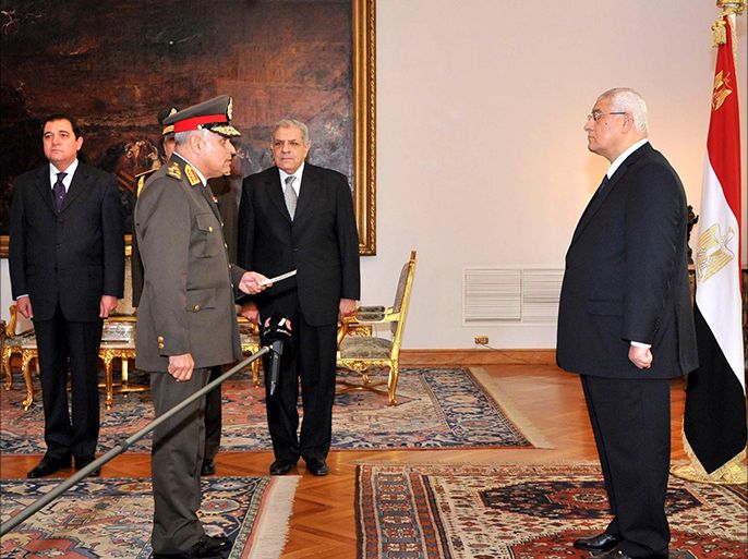 A handout picture made available by the Egyptian presidency shows Egypt's interim president Adly Mansour (R) swearing in Egypt’s newly appointed Defence Minister Colonel General Sedki Sobhi