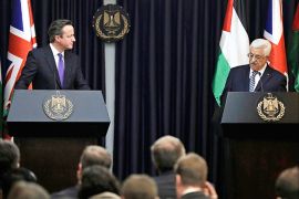 British Prime Minister David Cameron (L) listens to Palestinian President Mahmoud Abbas speak during their joint news conference in the West Bank town of Bethlehem March 13, 2014. Cameron is on a two-day visit in the region. He held separate talks with Israeli Prime Minister Benjamin Netanyahu and Abbas, who are at odds over U.S. proposals to keep peace talks going beyond an April target date for an agreement. REUTERS/Ammar Awad (WEST BANK - Tags: POLITICS)