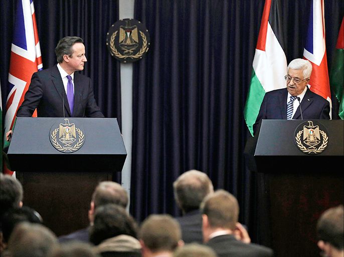 British Prime Minister David Cameron (L) listens to Palestinian President Mahmoud Abbas speak during their joint news conference in the West Bank town of Bethlehem March 13, 2014. Cameron is on a two-day visit in the region. He held separate talks with Israeli Prime Minister Benjamin Netanyahu and Abbas, who are at odds over U.S. proposals to keep peace talks going beyond an April target date for an agreement. REUTERS/Ammar Awad (WEST BANK - Tags: POLITICS)