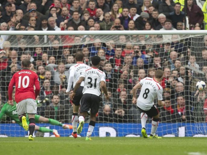 Liverpool's Steven Gerrard, right, scores his side's first goal against Manchester United during their English Premier League soccer match at Old Trafford Stadium, Manchester, England, Sunday March 16, 2014. (AP Photo/Jon Super)