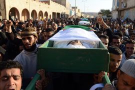 Algerian mourners carry the coffins of three members of the Chaamba community of Arab origin who were killed during sectarian clashes on March 17, 2014 in the town of Ghardaia, some 600 kilometres (370 miles) south of Algiers. The city of 90,000 inhabitants has been rocked since December by clashes between the Chaamba community of Arab origin and the majority Mozabites, indigenous Berbers belonging to the Ibadi Muslim sect. The latest violence erupted after hundreds of Mozabites who had fled during the initial unrest returned to their houses, to find many of them destroyed or badly damaged, according to various local sources. AFP PHOTO / FAROUK BATICHE