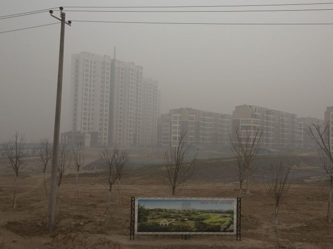 In this photo taken Wednesday, Feb. 26, 2014, an artistic rendering functioning as an advertisement of a residential real estate project is displayed on a severely polluted day in Shijiazhuang, in northern China's Hebei province. Combatting pollution has shot up the agenda of the ruling Communist Party, which for years pushed for rapid economic development with little concern about the environmental impact. Under public pressure to reduce the air pollution that blankets Beijing and cities across China, the country's leaders are rebalancing their priorities. (AP Photo/Alexander F. Yuan)