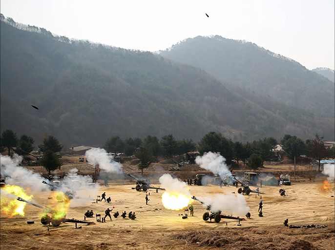 Towed 155mm Howitzers fire during an artillery drill in Inje, near the demilitarized zone (DMZ) which separates the two Koreas in this picture provided by South Korean Army and released by Yonhap on March 27, 2014. South Korea's military on Thursday seized a North Korean fishing boat that it said had crossed a disputed maritime border after ignoring warnings to retreat amid growing tension between the two sides. The incident comes as the North faces renewed pressure from the international community after it fired two mid-range missiles on Wednesday just as the leaders of South Korea, Japan and the United States