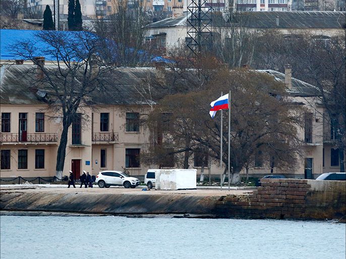The Russian flag flies at a Ukranian naval base in the Crimean port of Sevastopol March 20, 2014. Russia imposed retaliatory sanctions on nine U.S. officials and lawmakers on Thursday as tension over Moscow's annexation of Crimea mounted, warning the West it would hit back over "every hostile thrust". REUTERS/Shamil Zhumatov (UKRAINE - Tags: POLITICS MILITARY)