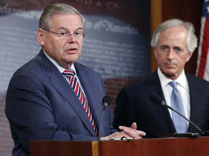 U.S. Senate Foreign Relations Committee Chairman Robert Menendez (D-NJ) (L) and ranking member Senator Bob Corker (R-TN) (R) hold a news conference after a Senate vote on an aid package for Ukraine at the U.S. Capitol in Washington March 27, 2014. REUTERS/Jonathan Ernst (UNITED STATES - Tags: POLITICS)