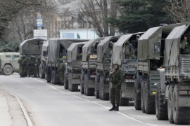 Armed servicemen wait in Russian army vehicles in the Crimean town of Balaclava March 1, 2014. Ukraine accused Russia on Saturday of sending thousands of extra troops to Crimea and placed its military in the area on high alert as the Black Sea peninsula appeared to slip beyond Kiev's control. REUTERS/Baz Ratner (UKRAINE - Tags: POLITICS MILITARY)