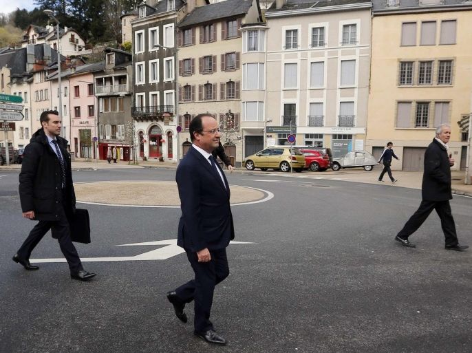 France's President Francois Hollande (C) walks in the street as he leaves after voting in the first round in the French mayoral elections in Tulle, center France, March 23, 2014. The French goes to the polls to cast votes in the two-round 2014 Municipal elections today and on March 30 to elect city mayors and councillors for a six-year term. REUTERS/Regis Duvignau (FRANCE - Tags: POLITICS ELECTIONS TPX IMAGES OF THE DAY)
