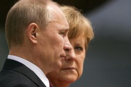 German Chancellor Angela Merkel looks at Russian President Vladimir Putin (L) as they listen to their national anthems before talks at the Chancellery in Berlin, in this June 1, 2012 file photo. Heavily dependent on Russian gas and closer to Moscow than any other leading western nation, Germany faces a major policy dilemma as the Ukraine crisis descends into a Cold War-style confrontation of tit-for-tat threats and ultimatums. For weeks, Merkel and her three-month old coalition government have gone out of their way to avoid antagonising Putin, remaining measured even as Washington and other capitals ratcheted up the rhetoric. REUTERS/Thomas Peter/Files (GERMANY - Tags: POLITICS CIVIL UNREST)