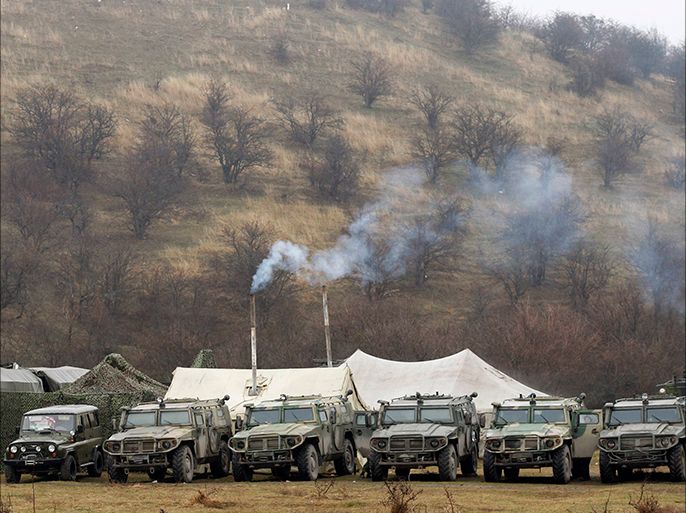 Military vehicles, believed to be property of the Russian army, are seen near the territory of a Ukrainian military unit in the village of Perevalnoye, outside Simferopol, March 7, 2014. Ukraine is ready for talks with Russia, but Moscow must first withdraw its troops, abide by international agreements and halt its support for "separatists and terrorists", Prime Minister Arseny Yatseniuk said on Friday. REUTERS/Vasily Fedosenko (UKRAINE - Tags: POLITICS MILITARY CIVIL UNREST)