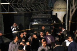 Policemen and members of the investigative team gather at the site of a bomb attack in front of the Israeli embassy in Cairo, March 11, 2014. A home-made bomb exploded in front of the Israeli embassy in Cairo on Tuesday, security sources and the website of state-run Al-Ahram newspaper said. Security sources said the explosion targeted a police car parked near the embassy, rather than the embassy itself and did not cause any injuries. REUTERS/Al Youm Al Saabi Newspaper (EGYPT - Tags: POLITICS CIVIL UNREST CRIME LAW) EGYPT OUT. NO COMMERCIAL OR EDITORIAL SALES IN EGYPT
