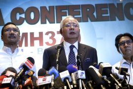 Malaysian Prime Minister Najib Razak, center, Malaysia's Minister for Transport Hishamuddin Hussein, left, and director general of the Malaysian Department of Civil Aviation, Azharuddin Abdul Rahman, delivers a statement to the media regarding the missing Malaysia Airlines jetliner MH370, Saturday, March 15, 2014 in Sepang, Malaysia. Najib said Saturday that investigators believe the missing Malaysian airliner's communications were deliberately disabled, that it turned back from its flight to Beijing and flew for more than seven hours. (AP Photo/Wong Maye-E)