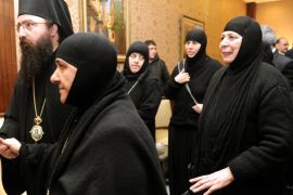 In this photo released by the Syrian official news agency SANA, a group of nuns who were freed after being held by rebels, greet church officials at the Syrian border town of Jdeidat Yabous, early Monday, March. 10, 2014. Rebels in Syria freed more than a dozen Greek Orthodox nuns on Monday, ending their four-month captivity in exchange for Syrian authorities releasing dozens of female prisoners. The release of the nuns and their helpers, 16 women in all, is a rare successful prisoner-exchange deal between Syrian government authorities and the rebels seeking to overthrow the rule of President Bashar Assad. (AP Photo/SANA)