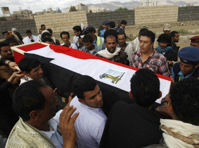 Yemeni mourners carry the coffin of a soldier who was killed by suspected al-Qaida militants at a checkpoint in Hadramawt province, during his funeral in Sanaa, Yemen, Sunday, March 30, 2014. Suspected al-Qaida militants attacked a security checkpoint in southeastern Yemen, first sending in a suicide car bomb then storming it, officials said on March 24. They killed 22 troops and left only one survivor, who pretended he was dead. (AP Photo/Hani Mohammed)