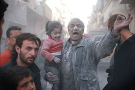 A Syrian man holds a crying girl as he gestures following an air strike by government forces on the Sahour neighbourhood of the northern Syrian city of Aleppo on March 6, 2014. AFP PHOTO / FADI AL-HALABI / AMC