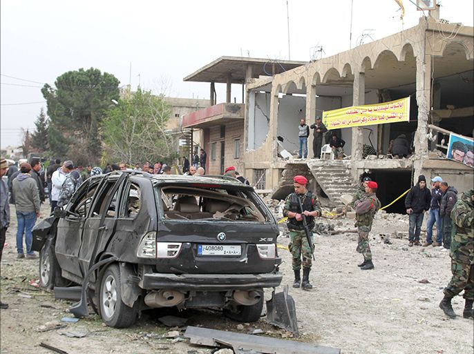 Lebanese security forces inspecting the site of a suicide car bomb attack in the village of Al-Nabi Othman, the Bekaa Valley, near the Syrian border on march 17, 2014, following a late night suicide attack. A suicide car bomb attack killed four people in an area dominated by the powerful Shiite movement Hezbollah