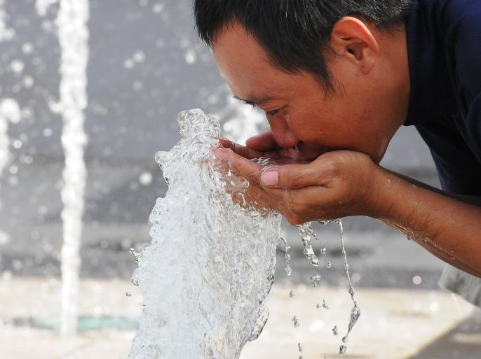 SURABAYA, INDONESIA - MARCH 22: A man drinks from a fountain in city park on World Water Day March 22, 2014 in Surabaya, Indonesia. Focusing on water and energy, World Water Day recognizes the global need to save, conserve and manage water resources responsibly for future generations. Both water and energy are in limited supply, yet global demand is increasing.