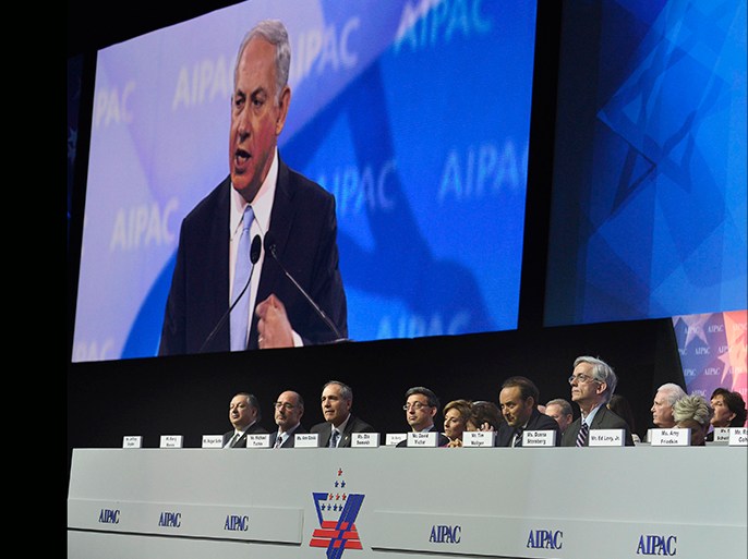Israeli Prime Minister Benjamin Netanyahu (on the monitor) addresses the American Israel Public Affairs Committee (AIPAC), as board members listen, in Washington, March 4, 2014. Netanyahu urged world powers on Tuesday not to allow Iran to retain the ability to enrich uranium, saying it must be stripped of all nuclear technologies with bomb-making potential. REUTERS/Mike Theiler (UNITED STATES - Tags: POLITICS)