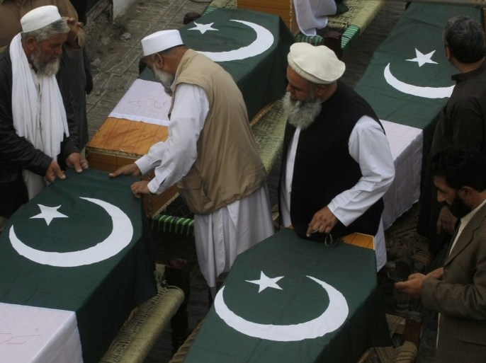 Pakistani relatives of police officers who were killed in Saturday bomb blasts prepare their caskets during their funeral, in Jamrud, near Peshawar, Pakistan, Saturday, March 1, 2014. The Pakistani Taliban announced Saturday that the group will observe a one-month cease-fire as part of efforts to negotiate a peace deal with the government, throwing new life into a foundering peace process. The violence Saturday showed how difficult it could be to enforce a cease-fire, let alone forge a peace agreement. (AP Photo/Mohammad Sajjad)