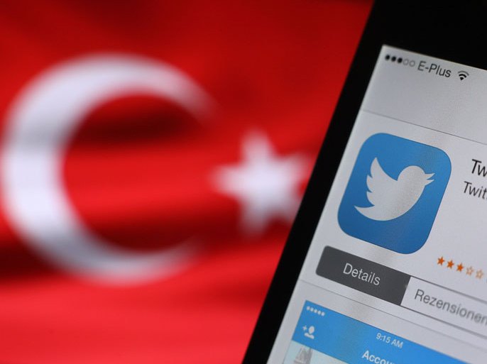 epa04134461 The logo of Twitter is seen on a smartphone held besides a Turkish flag in Kaufbeuren, Germany, 21 March 2014. The social media site Twitter was blocked in Turkey early on 21 March 2014, amid an internet crackdown in the country. Some users said they could not load the site, while others were being redirected to an official website saying a court order was applying 'protection measures.'The move came just hours after Turkish Prime Minister Recep Tayyip Erdogan promised to 'root out' Twitter, after pushing through new legislation last month which allows authorities to shut down websites and track users' browsing histories. EPA/Karl-Josef Hildenbrand