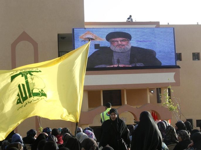 Hezbollah supporters listen to a speech by their leader Sayyed Hassan Nasrallah, projected on a giant screen, in Aineta village, in south Lebanon March 29, 2014. Hezbollah leader Sayyed Hassan Nasrallah on Saturday called for domestic support for his militants after a year of growing sectarian violence in Lebanon following the Shi'ite militant group's intervention in the Syrian war. REUTERS/ Sharif Karim (LEBANON - Tags: POLITICS CIVIL UNREST)