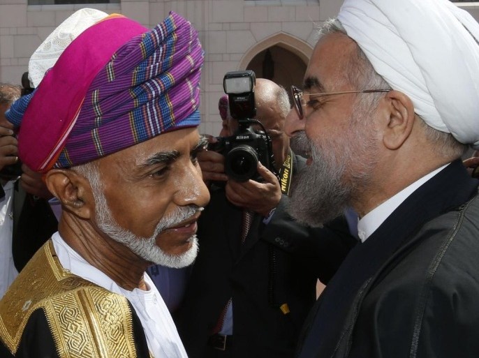Omani leader Sultan Qaboos bin Said (L) greets Iranian President Hassan Rouhani upon his arrival in Muscat on March 12, 2014. Rouhani arrived for a two-day visit to discuss bilateral cooperation and regional tensions. AFP PHOTO/MOHAMMED MAHJOUB