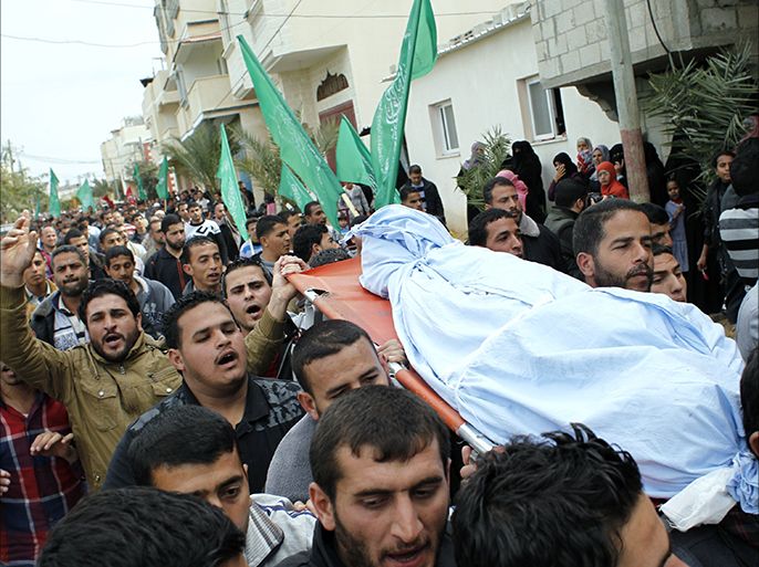 Palestinians carry the body of Amena Atiyyeh Qdeih, a mentally ill Gazan woman who was shot dead by Israeli troops near the border early on March 1, 2014, the Palestinian territory's Hamas-run health ministry said, during her funeral procession in the town of Khan Younis, in the southern Gaza Strip. The Israeli military confirmed soldiers had opened fire after several people approached the border security fence, hitting one of them. AFP PHOTO / SAID KHATIB