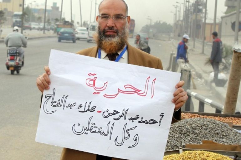 An Egyptian man holds a banner reading in Arabic 'freedom for (activists) Alaa Abdel-Fatah, Ahmad Abdel-Rahman and all detainees' in front of Tora prison, in Cairo, Egypt, 23 March 2014. An Egyptian court on 23 March 2014 freed Alaa Abdel-Fatah and co-defendant Ahmad Abdel-Rahman on a bail of 10,000 Egyptian pounds (around 1,428 dollars) each pending the resumption of the hearings on 06 April. Abdel-Fattah is standing trial along with 24 others for allegedly organizing an unauthorized protest in November 2013.
