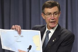 The chief coordinator of the Joint Agency Coordination Center retired Chief Air Marshall Angus Houston shows a map to the media during a press conference about the on going search operations for wreckage and debris of missing Malaysia Airlines Flight 370 in Perth, Australia, Monday, April 7, 2014. Houston reported the towed pinger locator deployed from the Ocean Shield has detected two signals consistent with those emitted by an in flight back box recorder, in the northern part of the current search area in the southern Indian Ocean. (AP Photo/Rob Griffith)