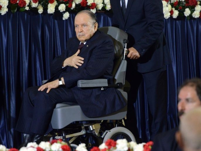 Algerian President Abdulaziz Bouteflikz is pushed in his wheelchair as he arrives for his inauguration ceremony as he is sworn as Algeria's President for a fourth term in Algiers on April 28, 2014. Official results showed that Bouteflika won 81.5 percent of the votes in an election marred by low turnout and claims of fraud by his opponents, including main rival Ali Benflis, who received just 12.18 percent. AFP PHOTO / FAROUK BATICHE