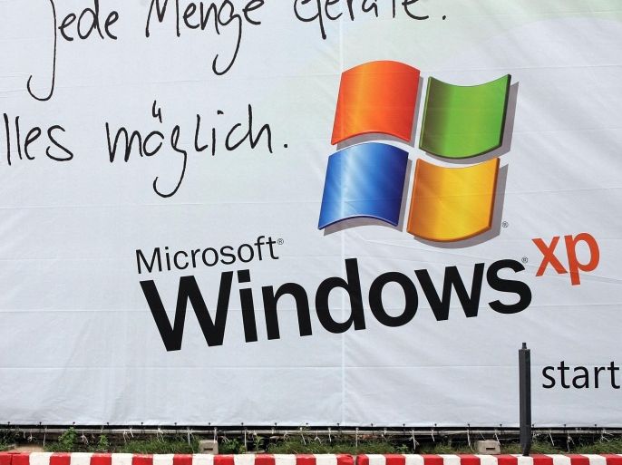 BERLIN - JUNE 1: A man with a digital camera prepares to take a picture next to a billboard advertising the Microsoft Windows XP operating system June 1, 2005 in Berlin, Germany. Microsoft is locked in a legal battle with the European Commission over how it sells its computer operating systems in Europe. Microsoft is waiting for a response today from the EC after submitting a proposal to resolve the dispute.