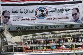 Egyptian holiday makers ride in a boat on the Nile River marking Sham el-Nessim, or “smelling the breeze,” in front of a giant banner supporting presidential hopeful Abdel-Fattah el-Sissi, the country's former military chief, in Cairo, Monday, April 21, 2014. Arabic reads,"the front of Sissi supporters, the popular presidential campaign." (AP Photo/Amr Nabil)