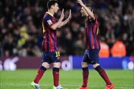 Barcelona's Argentinian forward Lionel Messi is congratulated by his teammate Barcelona's midfielder Andres Iniesta (R) after scoring during the Spanish league football match FC Barcelona vs Athletic Club Bilbao at the Camp Nou stadium in Barcelona on April 20, 2014. AFP PHOTO/ JOSEP LAGO
