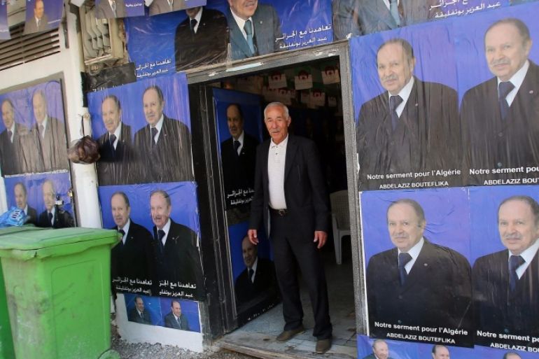 An Algerian man stands next to electoral campaign posters for Algerian President Abdelaziz Bouteflika in Algiers, Algeria, 16 March 2014. The Algerian Constitutional Council announced on 13 March 2014 a list of six candidates who will run in the presidential elections scheduled for 17 April.