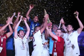 El-Jaish's players celebrate with their trophies after they won against Lekhwiya the Qatar's Crown Prince Cup final football match on April 26, 2014 at Abdullah bin Nasser bin Khalifa stadium in Doha. AFP PHOTO/AL-WATAN DOHA/KARIM JAAFAR == QATAR OUT ==