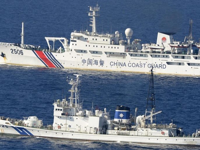 In this Wednesday, Sept. 11, 2013 photo, a China coast guard vessel numbered 2506, top, sails along the Japan coast guard ship Katori in the continuous zone of Japan's territorial waters off the disputed East China Sea islands called Senkaku in Japanese and Diaoyutai in Chinese. A big problem for China is its bad blood with virtually all of its neighbors, many of whom are key players in the search of missing Malaysia Airlines Boeing 777. China has territorial disputes with India, Japan, the Philippines and Vietnam, and many other countries in the region are wary of its efforts to exert more control over Pacific shipping lanes that could impact their freedom of trade. (AP Photo/Kyodo News) JAPAN OUT, MANDATORY CREDIT