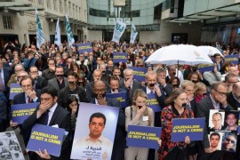 A handout photo dated 07 April 2014 and made available by BBC showing a protest in London, Britain, by BBC journalists in support of Aljazeera staff held under captivity in Egypt. BBC journalists gathered for a one minute silence with their mouths covered. EPA/JEFF OVERS / HANDOUT