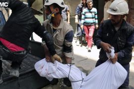 This photo provided by the anti-government activist group Aleppo Media Center (AMC), which has been authenticated based on its contents and other AP reporting, shows civil defense rescue workers carrying the body of a man who was killed by a government forces airstrike, in Aleppo, Syria, Monday, April 28, 2014. Dozens of people were killed and wounded in fighting between pro-Assad forces and rebels in the northern city of Aleppo on Sunday, reported the Britain-based Syrian Observatory for Human Rights. The fight for Aleppo is particularly important now, with analysts saying they expect Assad's forces will try wrest as much of the city as possible before elections. (AP Photo/Aleppo Media Center AMC)