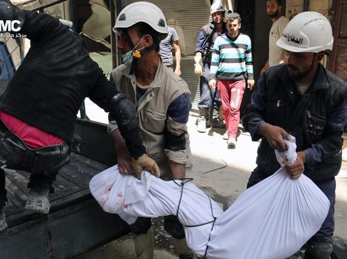 This photo provided by the anti-government activist group Aleppo Media Center (AMC), which has been authenticated based on its contents and other AP reporting, shows civil defense rescue workers carrying the body of a man who was killed by a government forces airstrike, in Aleppo, Syria, Monday, April 28, 2014. Dozens of people were killed and wounded in fighting between pro-Assad forces and rebels in the northern city of Aleppo on Sunday, reported the Britain-based Syrian Observatory for Human Rights. The fight for Aleppo is particularly important now, with analysts saying they expect Assad's forces will try wrest as much of the city as possible before elections. (AP Photo/Aleppo Media Center AMC)