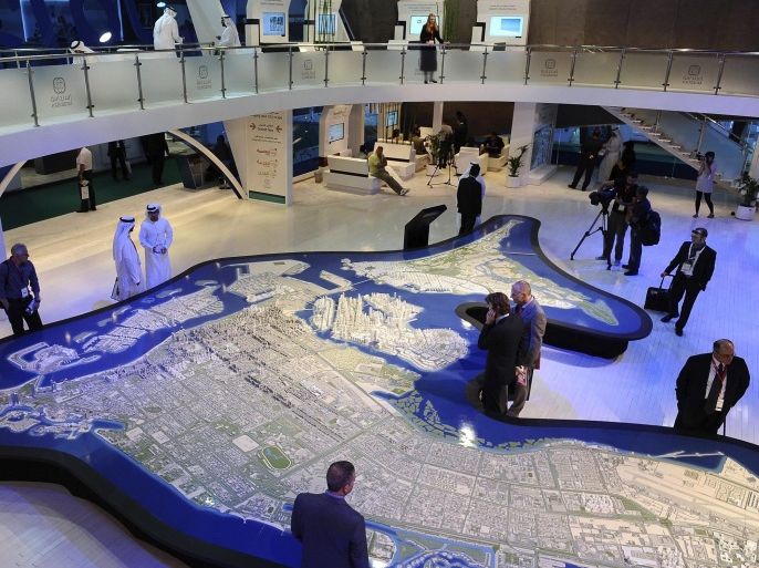 Visitors look at a project model during the first day of Cityscape at Abu Dhabi National Exhibition Center April 22, 2012. Government authorities, investors, developers and real estate professionals attend the annual Cityscape Abu Dhabi to discuss and encourage growth in Abu Dhabi's real estate market. The exhibition runs until April 25, 2012. REUTERS/Jack Issa (UNITED ARAB EMIRATES - Tags: CITYSPACE REAL ESTATE BUSINESS)