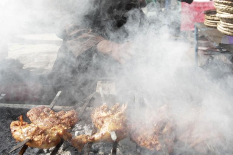 Mohammad Khan, 30, cooks kabab at an amusement park in Jalalabad, Afghanistan, Wednesday, Nov. 14, 2012.