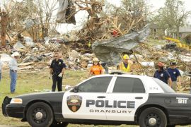 Rescue workers leave a debris area where seven people are still missing and six people are confirmed dead after a tornado touched down in the Rancho Brazos subdivision in Granbury, Texas, USA 16 May 2013.