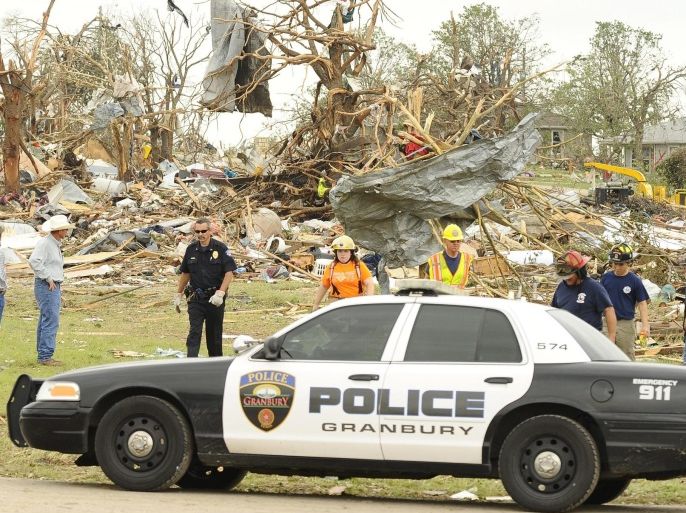 Rescue workers leave a debris area where seven people are still missing and six people are confirmed dead after a tornado touched down in the Rancho Brazos subdivision in Granbury, Texas, USA 16 May 2013.