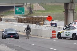 Vehicles are checked outside of the Bernie Beck Gate, Wednesday, April 2, 2014, in Fort Hood, Texas. At least one person was killed and 14 injured in a shooting at Fort Hood, and officials at the base said the shooter is believed to be dead. (AP Photo/American-Statesman, Deborah Cannon)