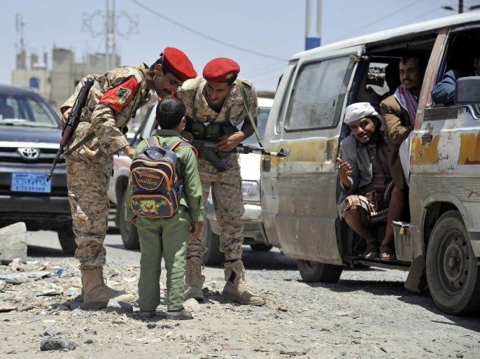 A student asks Yemeni soldiers to help access a street as authorities stepped up security measures a day after a drone attack killed 10 al-Qaeda suspected militants, in Sanaa, Yemen, 20 April 2014. An unspecified number of insurgents with suspected ties to al-Qaeda were killed 20 April 2014 in an airstrike in southern Yemen, a security official said, the second such attack in two consecutive days in the Arabian Peninsula country.