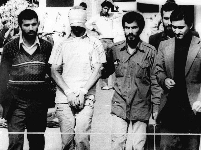 FILE - In this Nov. 9, 1979, file photo, one of the hostages being held at the U.S. Embassy in Tehran is displayed blindfolded and with his hands bound to the crowd outside the embassy. The U.S. and Iran cut off diplomatic ties in 1979 after the Islamic Revolution and the storming of the U.S. Embassy in Tehran, where 52 Americans were held hostage for more than a year. Since his inauguration in 2009, President Barack Obama has expressed a willingness to meet with the Iranians without conditions. The U.S. and Iran secretly engaged in high-level, face-to-face talks, at least three times over the past year, in a high stakes diplomatic gamble by the administration that paved the way for the historic deal aimed at slowing Iran's nuclear program. (AP Photo/File)